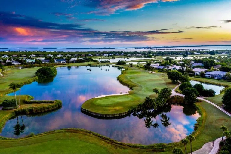 Aerial view of the Dunes golf course with a rainbow sky